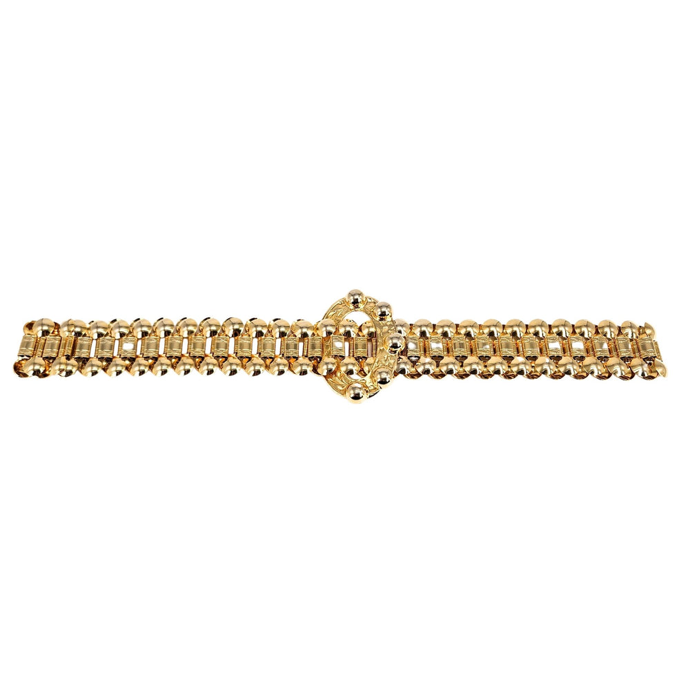 Gold bracelet with a decorative clasp on a white background