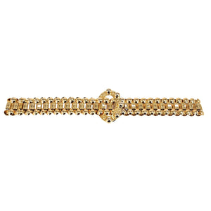 Gold bracelet with a decorative clasp on a white background