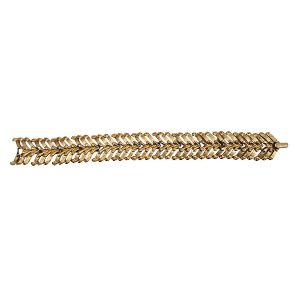 gold tone bracelet on white background 