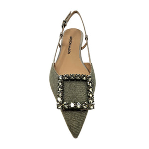 Green pointed-toe shoe with embellishments on a white background