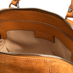 Close-up of a brown leather handbag with visible brand name.