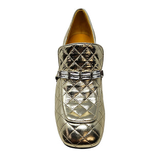 Gold quilted loafer shoe on a white background