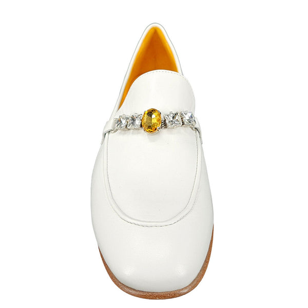 White shoe with a decorative band featuring a yellow gemstone on a white background