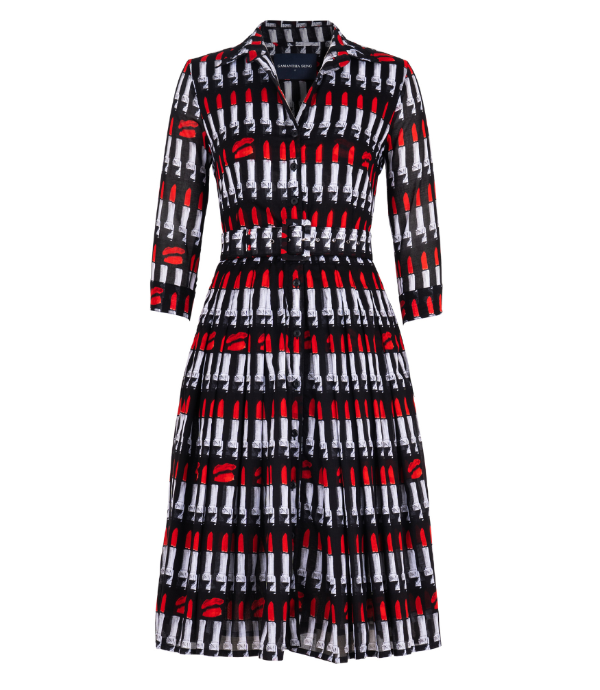 A knee-length dress with a collared neckline, three-quarter sleeves, and a flared skirt. Features a bold allover abstract pattern and fitted waist.