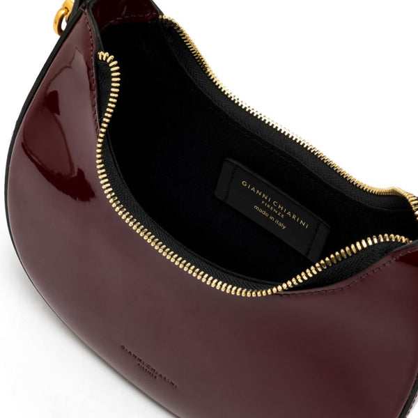 Gianfranco Ferré handbag with gold zipper on a white background