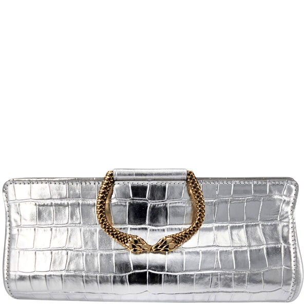 Silver clutch with gold chain handle on a white background