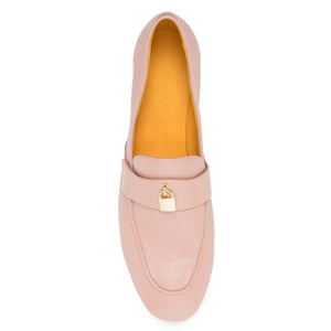 Pink loafer shoe with a gold buckle on a white background