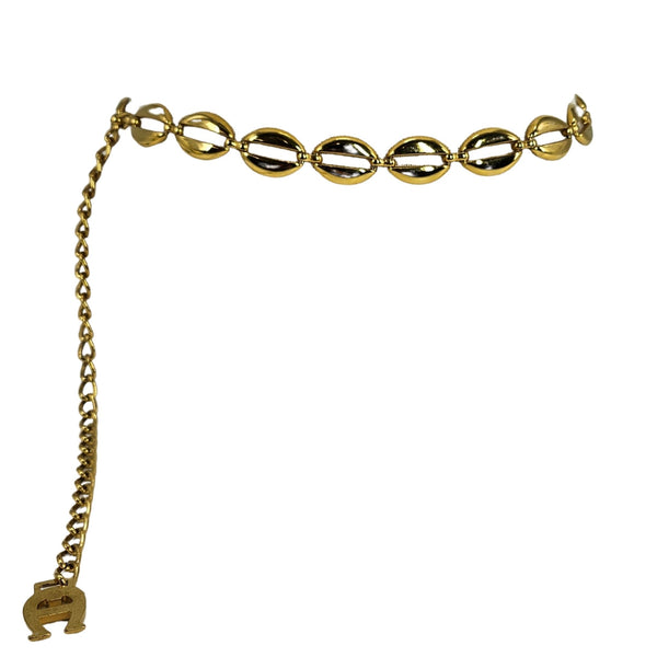 Gold chain belt with a small elephant charm on a white background