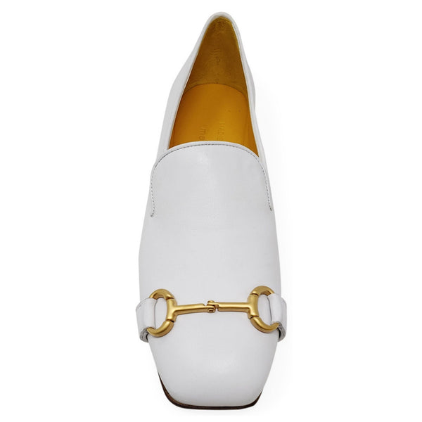 White loafer with gold horsebit detail on a white background