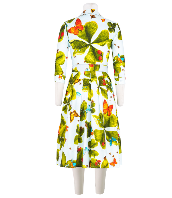A knee-length dress with a collared neckline, three-quarter sleeves, and a flared skirt. Features a bold allover abstract pattern and fitted waist.