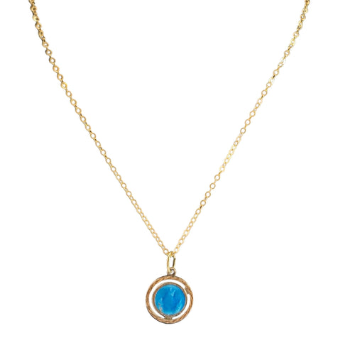 Gold necklace with a blue pendant on a white background