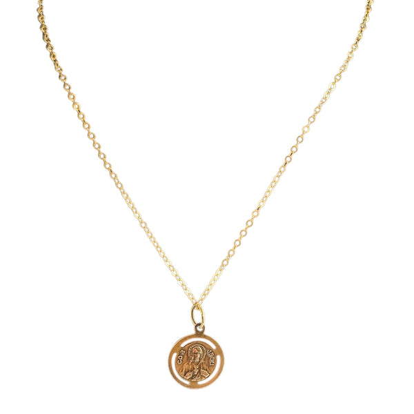 Gold necklace with a round pendant on a white background