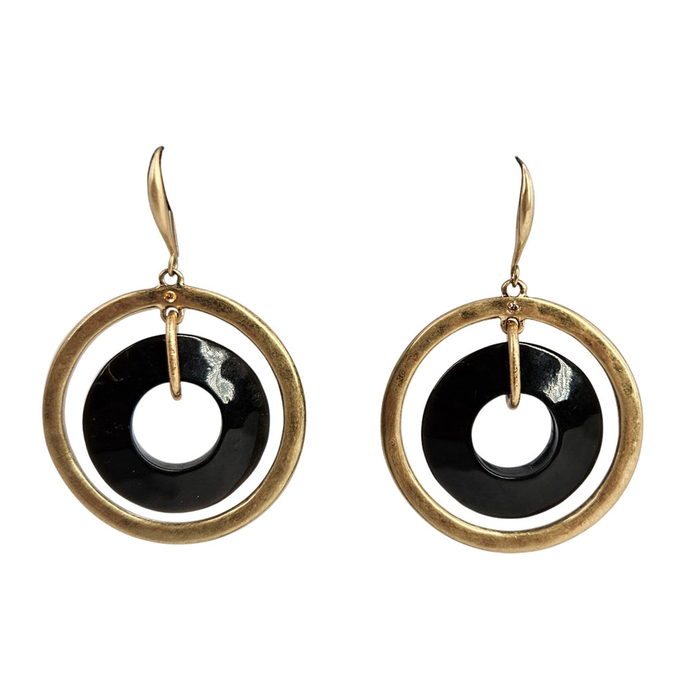 Gold hoop earrings with black and white circular designs on a white background