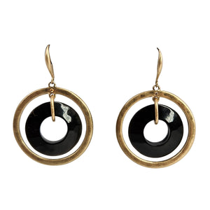 Gold hoop earrings with black and white circular designs on a white background