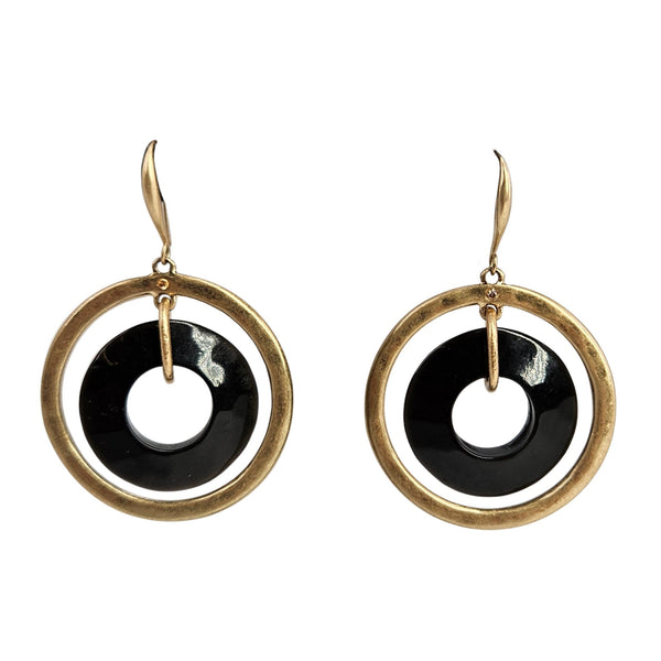 Gold hoop earrings with black and white circular designs on a white background