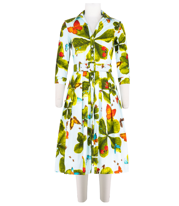 A knee-length dress with a collared neckline, three-quarter sleeves, and a flared skirt. Features a bold allover abstract pattern and fitted waist.