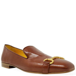 Brown leather loafer with gold buckle on a white background