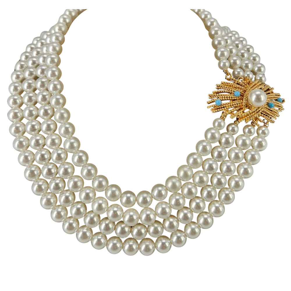 Pearl necklace with a gold clasp on a white background