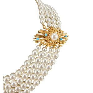 Pearl necklace with a gold and turquoise pendant on a white background