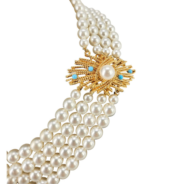 Pearl necklace with a gold and turquoise pendant on a white background