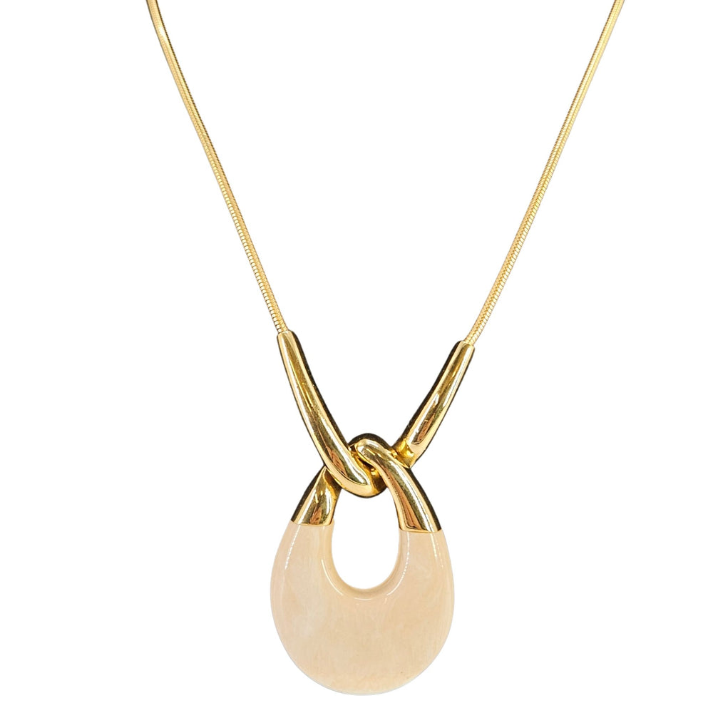 Gold necklace with a beige pendant on a white background