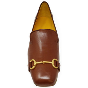 Brown leather loafer with gold buckle on a white background