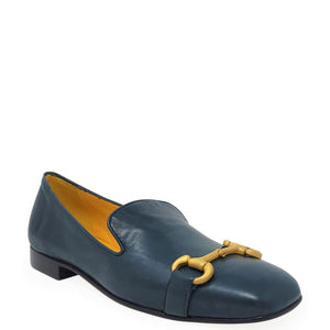 Blue loafer with yellow buckle on a white background