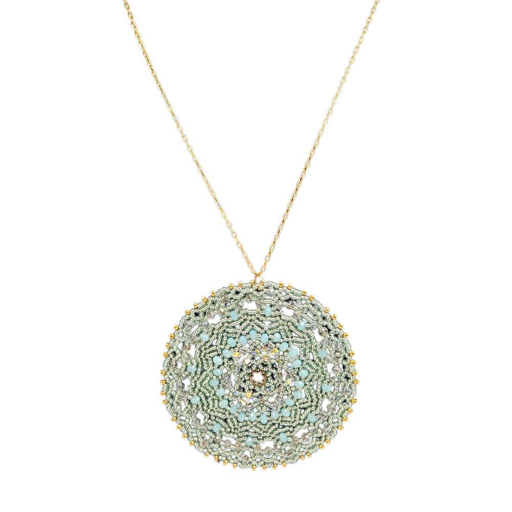 Decorative necklace with a round, beaded pendant on a white background