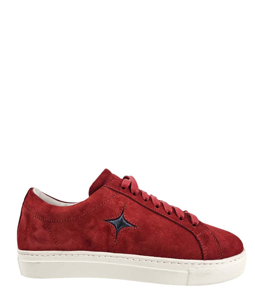  Side profile of a red suede sneaker with a dark blue star applique on the outer side. The sneaker features red laces, a white rubber sole, and a light-colored lining.