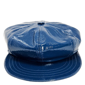 Blue patent leather cap on a white background