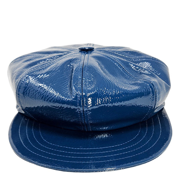 Blue patent leather cap on a white background