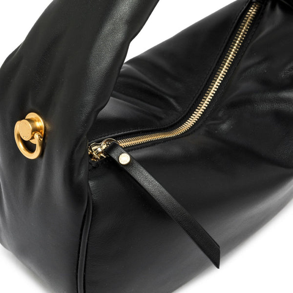 Black handbag with gold zipper and clasp on a white background