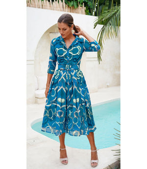 A knee-length dress with a collared neckline, three-quarter sleeves, and a flared skirt. Features a bold allover abstract pattern and fitted waist.