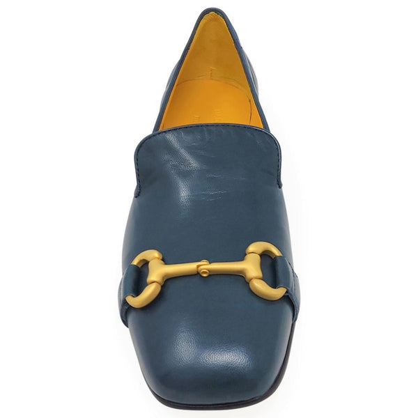 Blue loafer with yellow buckle on a white background