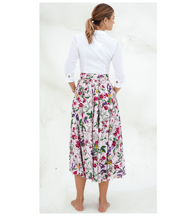 A knee-length dress with a collared neckline, three-quarter sleeves, and a flared skirt. Features a bold allover abstract pattern and fitted waist.