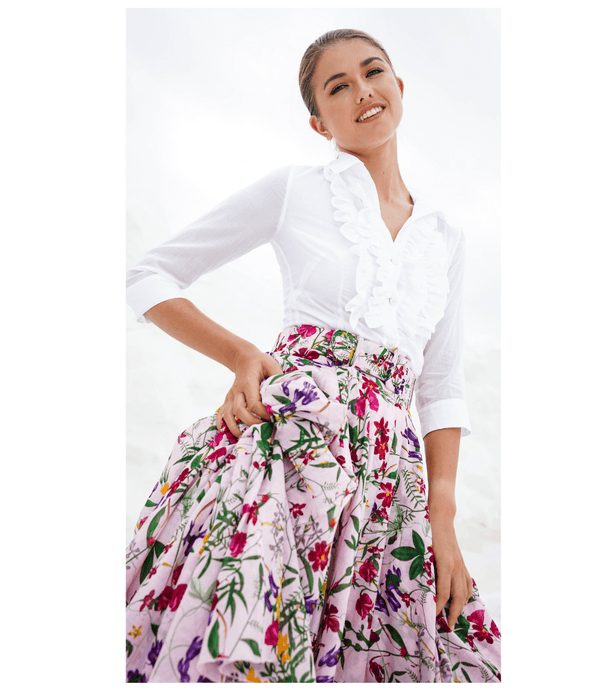 A knee-length dress with a collared neckline, three-quarter sleeves, and a flared skirt. Features a bold allover abstract pattern and fitted waist.