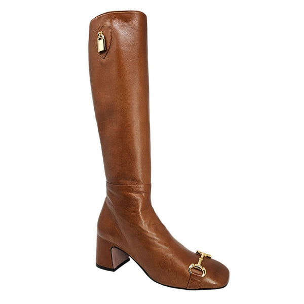Brown knee-high boot with gold accents on a white background
