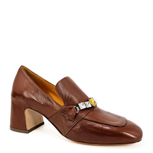 Brown leather loafer with decorative buckle on a white background