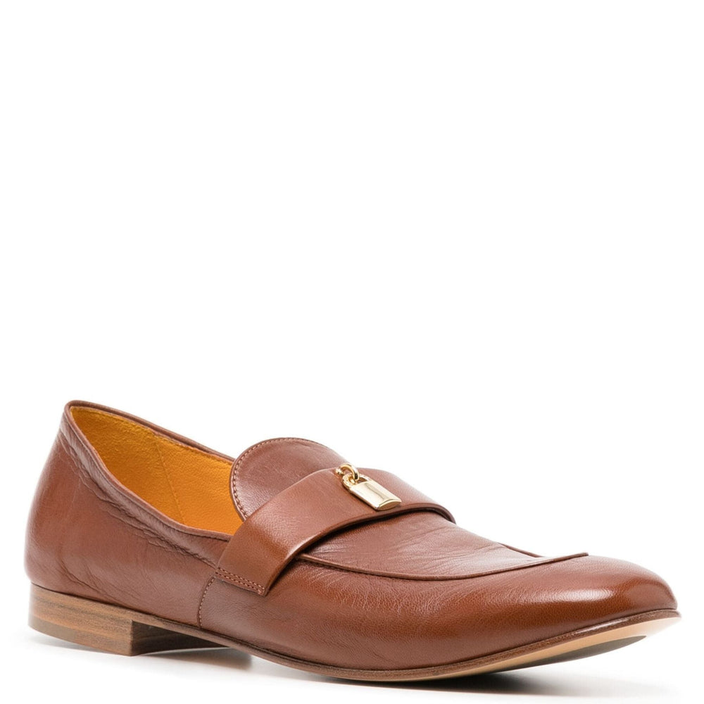 Tan leather flat loafer with lock buckle strap and moc toe stitching