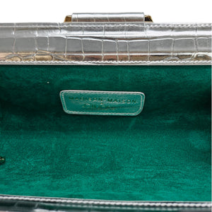 Green handbag with a visible brand label on a clear background