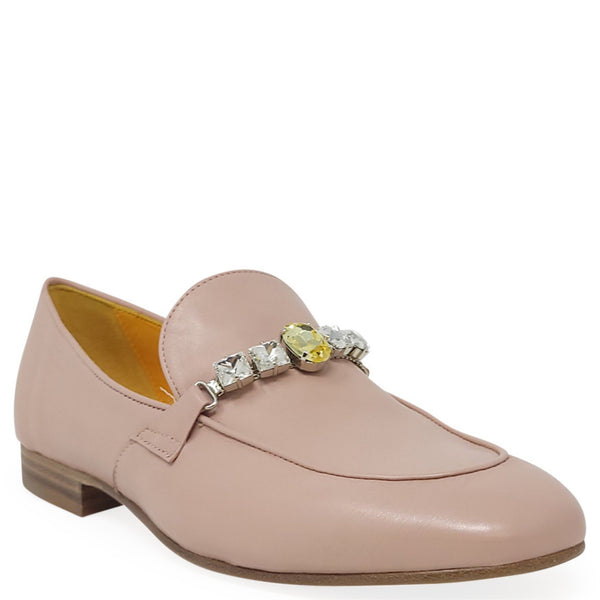 Pink loafer with decorative embellishments on a white background