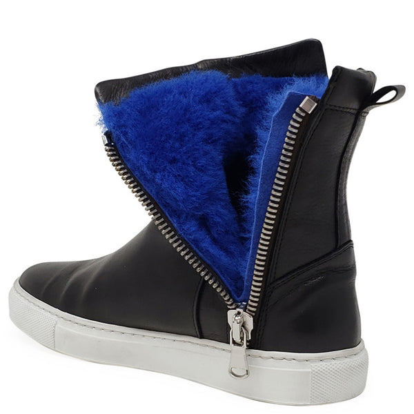 Black boot with blue fur lining and silver zipper on a white background
