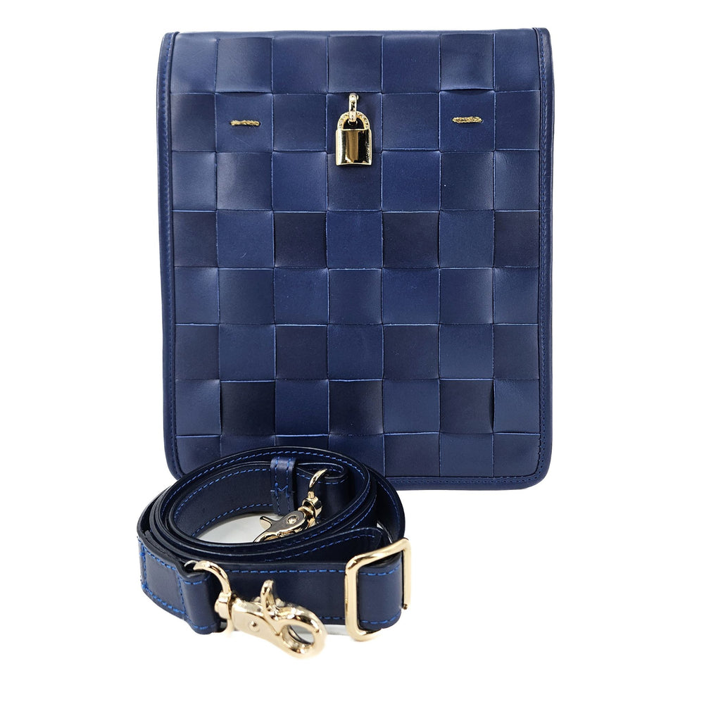 Blue woven handbag with gold accents on a white background