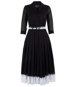 A knee-length dress with a collared neckline, three-quarter sleeves, and a flared skirt. Features a bold allover abstract pattern and fitted waist.