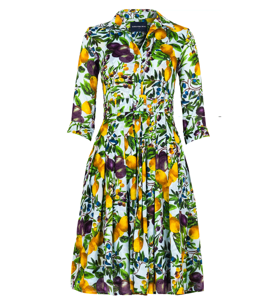 A knee-length dress with a collared neckline, three-quarter sleeves, and a flared skirt. Features a bold allover abstract pattern and fitted waist.