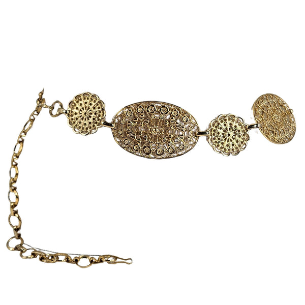 Gold bracelet with intricate designs on a white background