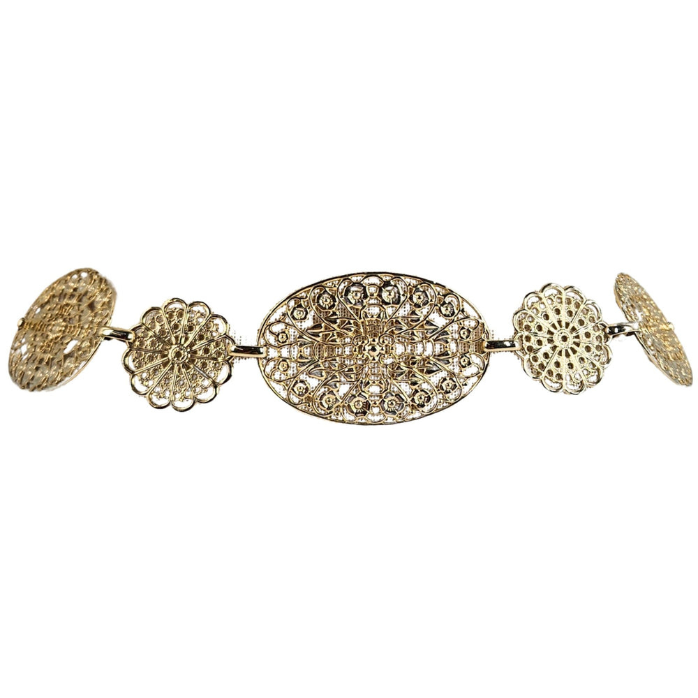 Gold brooch with floral and oval designs on a white background