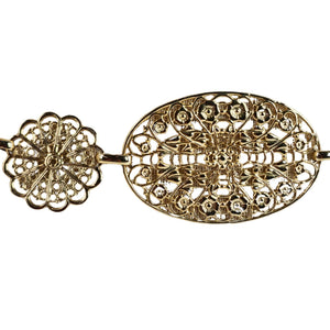Gold filigree earring on a white background