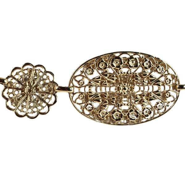 Gold filigree earring on a white background
