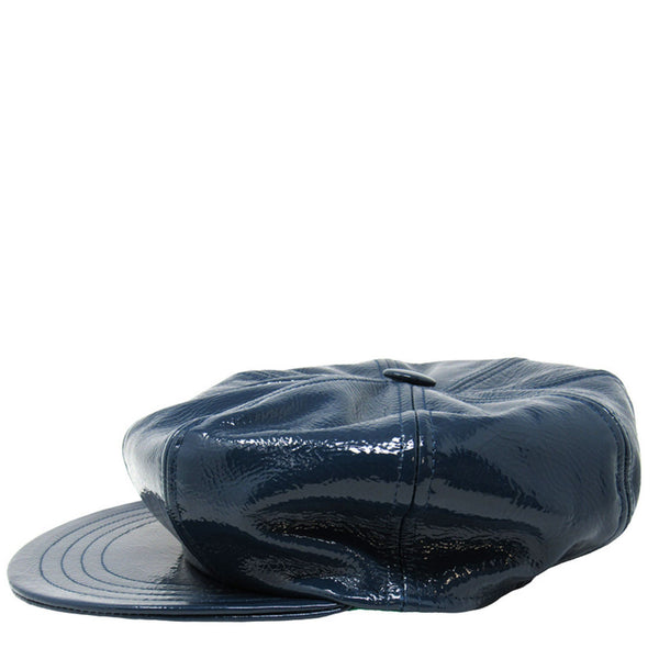 Blue patent leather cap on a white background